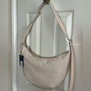 UNIVERSAL THREAD Cream moon shaped, soft feel, purse & wide adjustable strap NWT